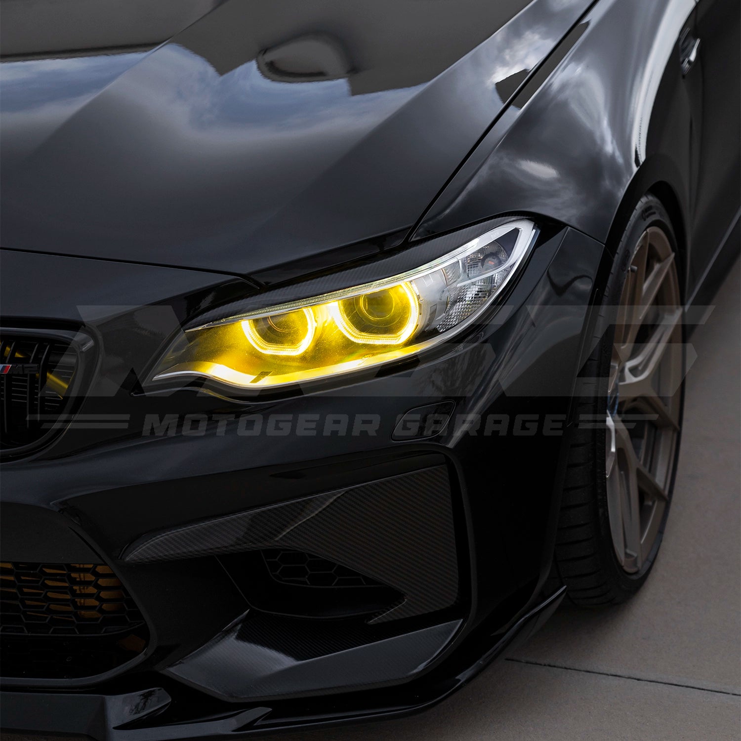 BMW F87 M2 with CSL style yellow DRL LED modules ON.