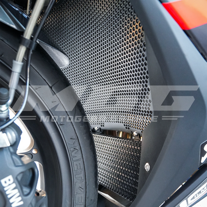 Close-up view of the MGG black aluminum radiator and oil cooler guard installed on a BMW S1000RR, focusing on the protective mesh and metal construction.